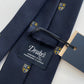 Drakes Navy Silk Tie with Crest Motif – A Touch of British Heritage
