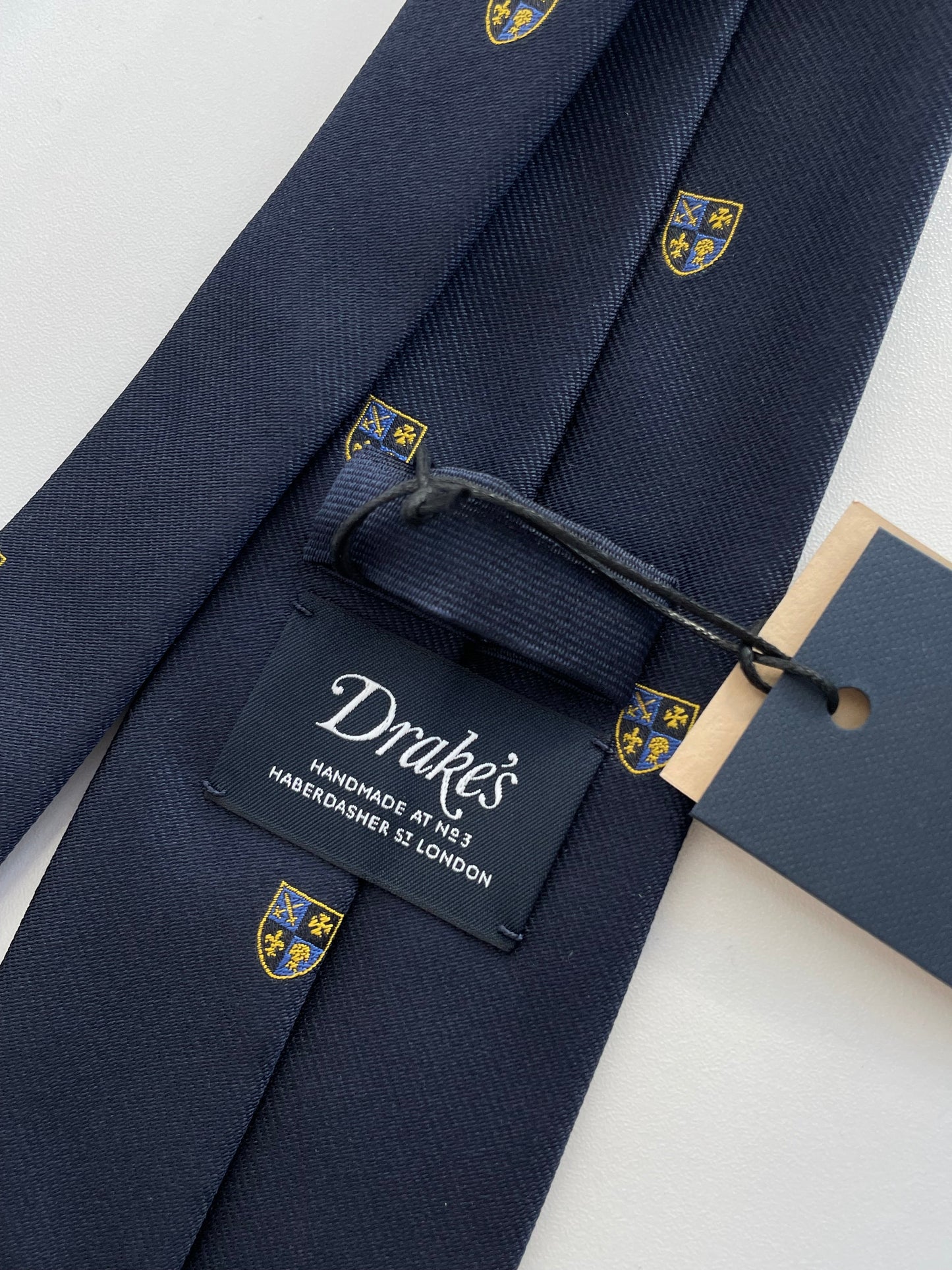 Drakes Navy Silk Tie with Crest Motif – A Touch of British Heritage
