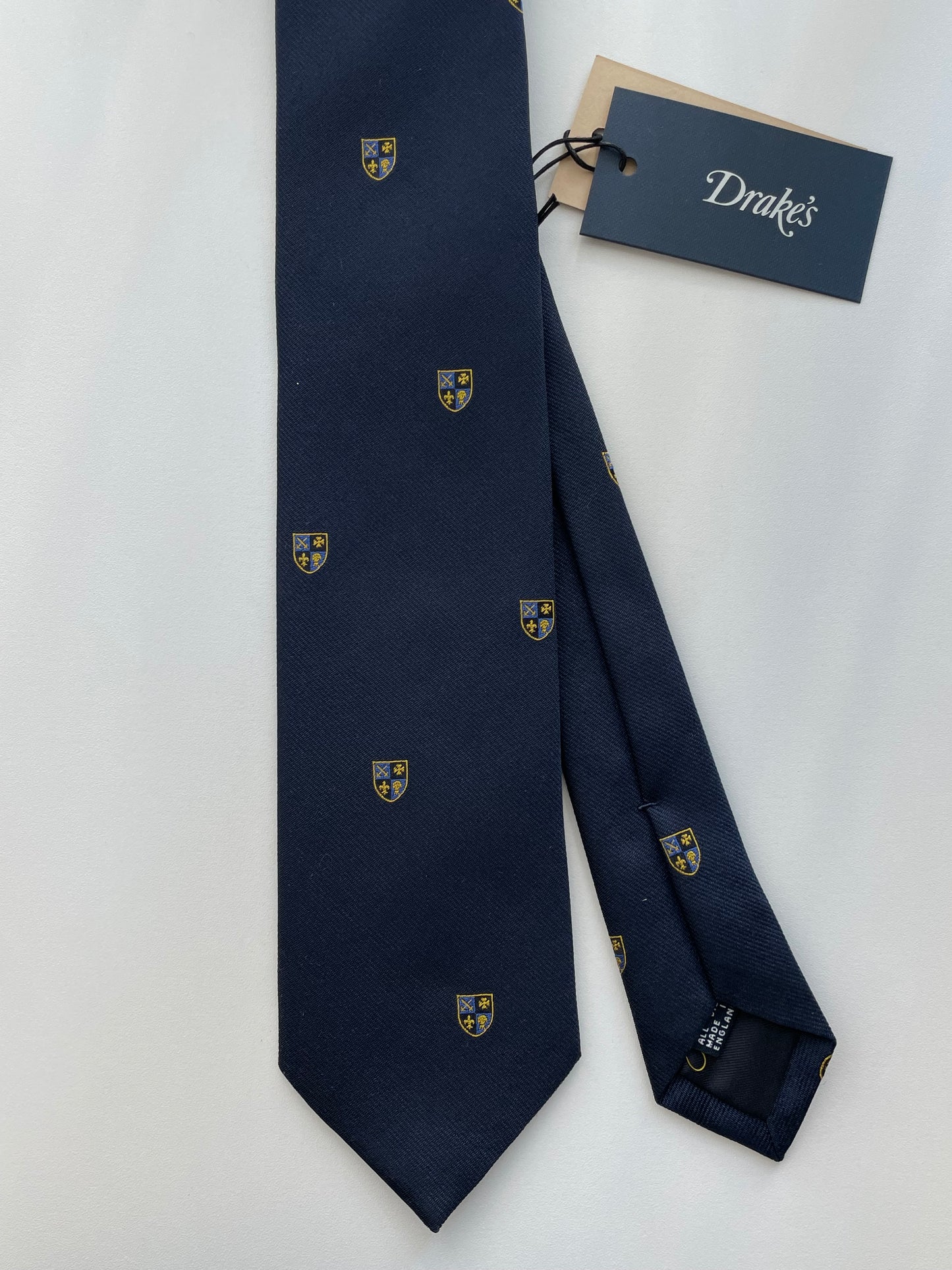 Drakes Navy Silk Tie with Crest Motif – A Touch of British Heritage