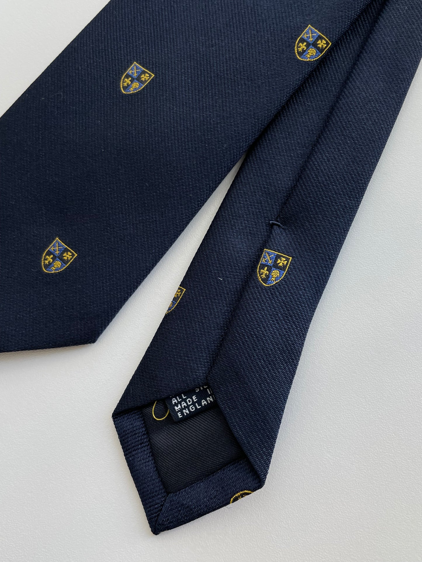 Drakes Navy Silk Tie with Crest Motif – A Touch of British Heritage