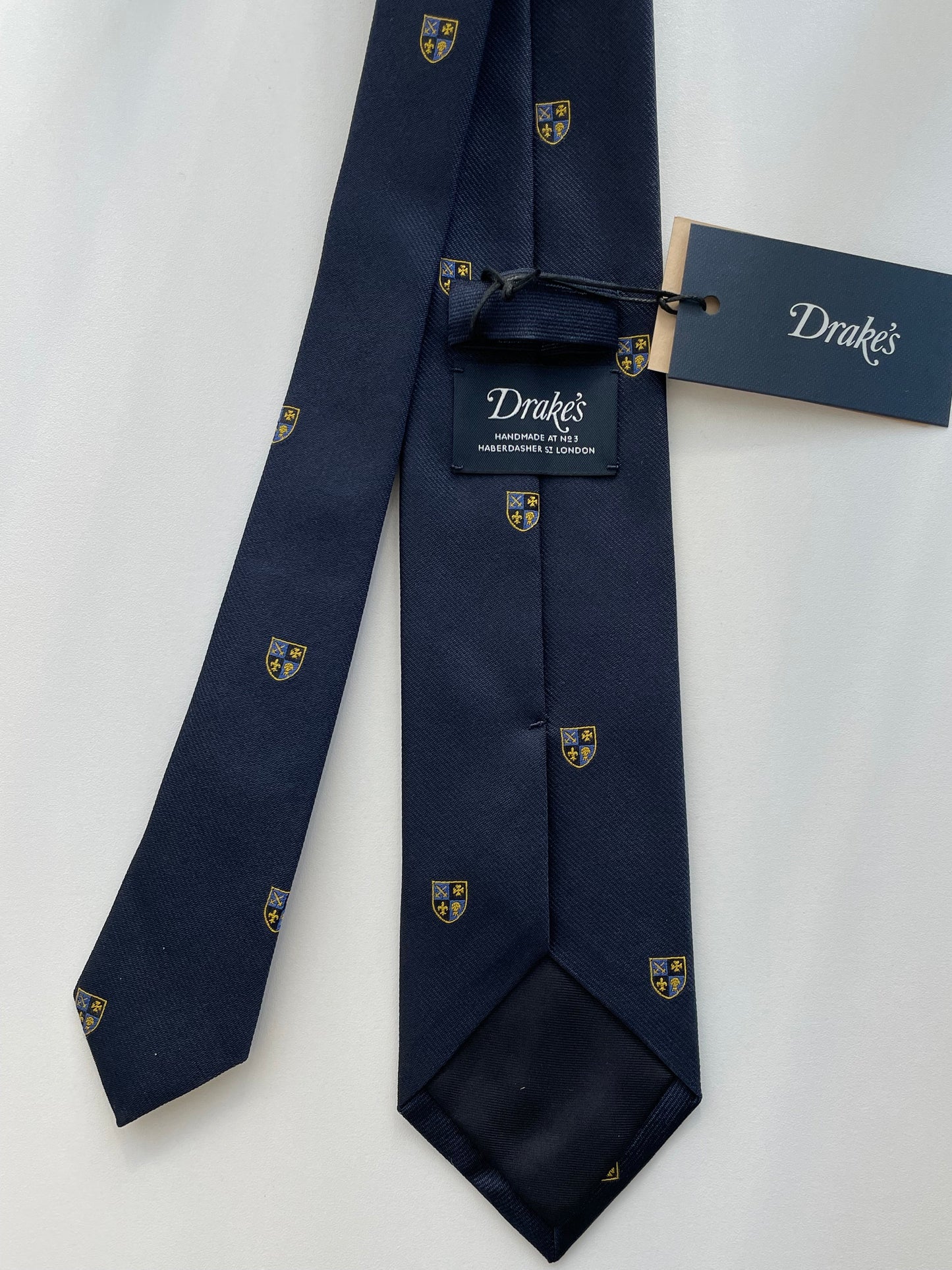 Drakes Navy Silk Tie with Crest Motif – A Touch of British Heritage